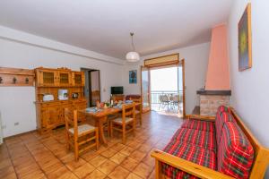 a kitchen and dining room with a table and chairs at Residence Bellevue Country Style - Happy Rentals in Tremosine Sul Garda