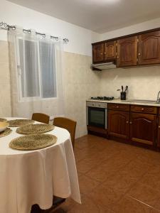 a kitchen with two tables and a stove top oven at Porto Santo Island Ocean Apartment in Vila Baleira