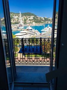 a view of a harbor from a balcony with a bench at Résidence Rauba Capeu in Nice