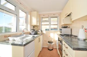 a kitchen with a sink and a counter top at 2 Brambles Farm Holiday Bungalow in Freshwater