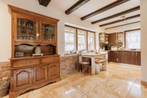 a kitchen with wooden cabinets and a table at Taszówka in Taszów +63 photos