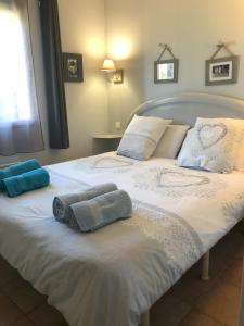 a large white bed with two towels on it at Le Mazet De Lélé in Saint-Rémy-de-Provence