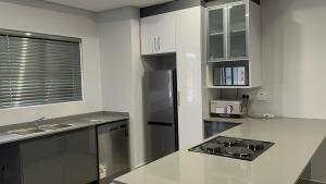 a kitchen with a refrigerator and a counter top at 49 on Blackburn in Durban