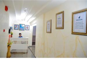 a person sitting at a reception desk in a room at Belmorris Hotel in Ilorin