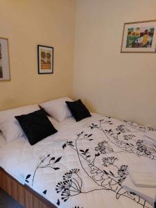 a bed with a black and white blanket on it at Apartment Pamela in Gajac