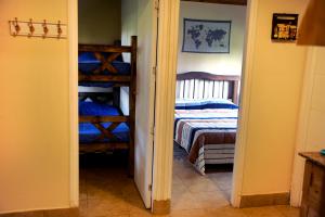 a bedroom with a bed and a bunk bed at Cabañas La Carmela Piedras B Potrerillos in Potrerillos