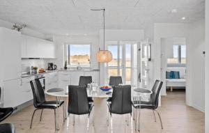 a kitchen and dining room with a table and chairs at Amazing Apartment In Ringkbing With Wifi in Ringkøbing