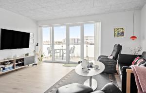 a living room with a couch and a table at Cozy Apartment In Ringkøbing With Wifi in Ringkøbing