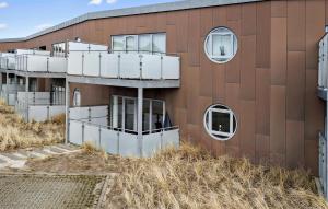 an external view of a building with circular windows at Amazing Apartment In Ringkbing With Wifi in Ringkøbing