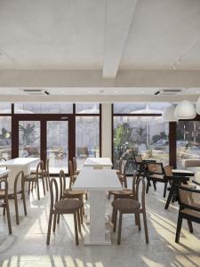 a dining room with tables and chairs and windows at Zen Vama Veche in Vama Veche