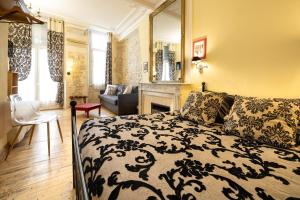 a bedroom with a bed and a living room at Hotel de La Paix in La Rochelle