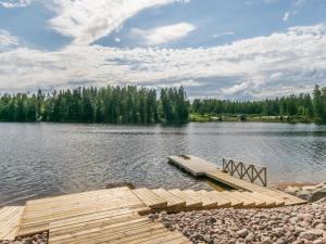 a dock in the middle of a lake at Holiday Home Villa kaislaranta by Interhome in Iitti