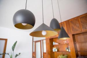 four pendant lights hanging from the ceiling in a room at Panoramic Ocean view in Puerto de Santiago