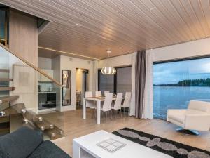 a living room and dining room with a view of the water at Holiday Home Villa joutseno by Interhome in Imatra