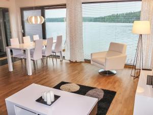 a living room with a table and chairs at Holiday Home Villa joutseno by Interhome in Imatra
