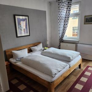 2 camas individuales en un dormitorio con ventana en Pension Olé, en Dresden