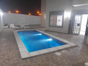 a large swimming pool in a room with at Villa phare 1 Midoun in Midoun