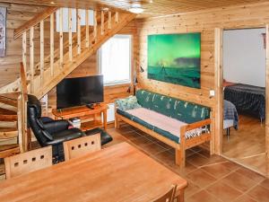 a living room with a couch and a tv at Holiday Home Lomahuoneisto b by Interhome in Utsjoki