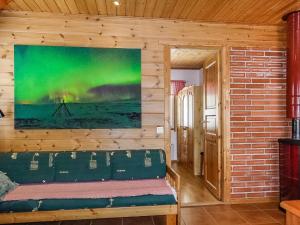 a room with a couch and a painting on the wall at Holiday Home Lomahuoneisto b by Interhome in Utsjoki +8 photos