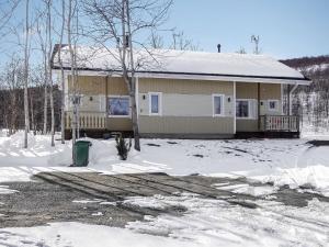 a house with snow on the ground in front of it at Holiday Home Lomahuoneisto b by Interhome in Utsjoki