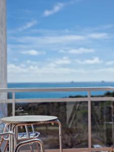 a table and chairs on a balcony overlooking the ocean at Hotel Sant Jordi in Tarragona