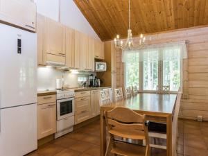 eine Küche mit weißen Geräten und einer Holzdecke in der Unterkunft Holiday Home Koivuranta by Interhome in Lamppi