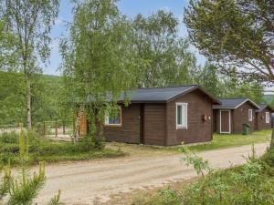 a cabin in the woods with a dirt road at Holiday Home Nilla 3 by Interhome in Utsjoki