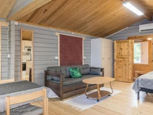 a room with a couch and a bed and a table at Holiday Home Nilla 3 by Interhome in Utsjoki +17 photos