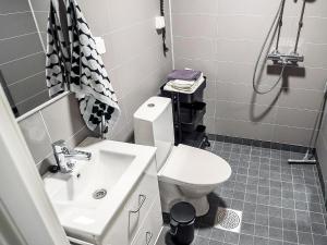 a bathroom with a toilet and a sink at Holiday Home Rakkaranta a- lentäjän poika 1 by Interhome in Hyrynsalmi