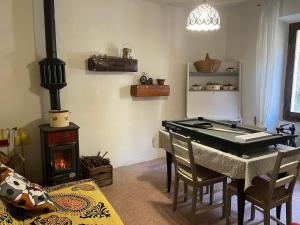 a living room with a pool table and a stove at Casa della Nonna in Porretta Terme