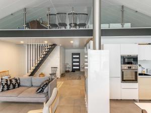 an open living room and kitchen with a loft at Holiday Home Villa honkarinne by Interhome in Jyväskylä