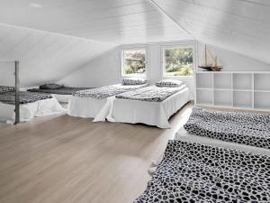 a room with two beds and two windows at Holiday Home Villa honkarinne by Interhome in Jyväskylä