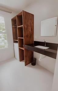 a bathroom with a sink and a mirror at Familia Pansini casa na Pipa in Pipa