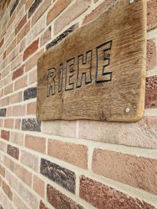 aire sign on the side of a brick wall bij Haus Riehe - b50841 in Haselünne