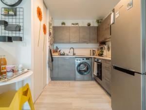 a kitchen with a washer and dryer in it at Apartment Les Rives de la Rance by Interhome in La Richardais