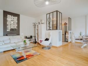 a living room with a white couch and a table at Apartment Les Rives de la Rance by Interhome in La Richardais