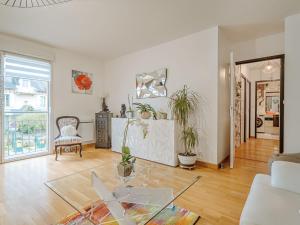 a living room with a glass table in the middle at Apartment Les Rives de la Rance by Interhome in La Richardais