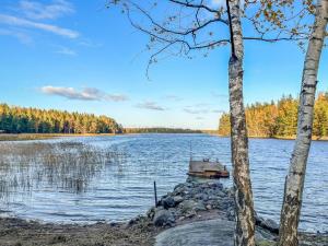 a boat on the shore of a lake at Holiday Home Villa haave by Interhome 