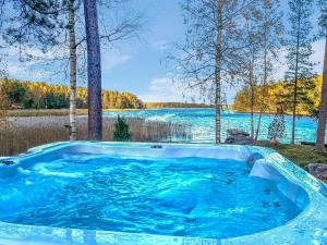 a jacuzzi tub with a view of a lake at Holiday Home Villa haave by Interhome 