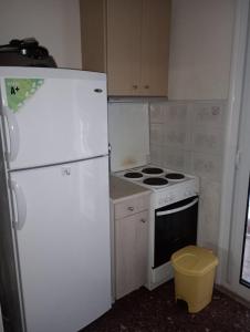 a kitchen with a stove and a white refrigerator at Apartment Asprovalta, Greece close to the center and the beach in Asprovalta