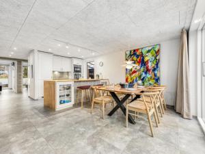 a kitchen and dining room with a table and chairs at Holiday Home Elisabetha - 100m from the sea in Western Jutland by Interhome in Esbjerg