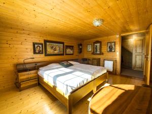 a bedroom with a bed in a wooden cabin at Holiday Home Laderen 7 by Interhome in Oberegg