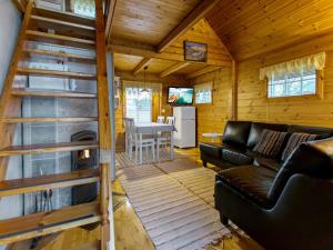 a living room with a couch and a table in a cabin at Holiday Home Missi by Interhome 