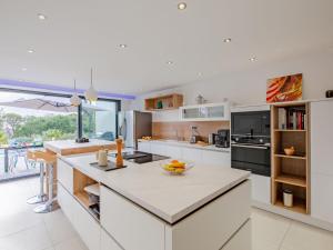 une cuisine avec des placards blancs et un grand îlot dans l'établissement Villa Les Girelles by Interhome, aux Issambres 32 autres photos