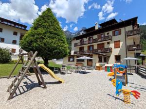 a playground in front of a building at Hotel La Nuova Montanina in Auronzo di Cadore