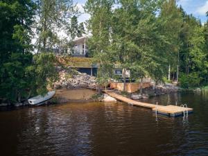 a house on the shore of a river with a dock at Holiday Home Vapunkärki by Interhome in Orivesi +41 photos
