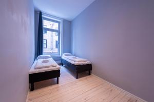 a room with two beds and a window at Maya Apartments - Sentrum in Oslo