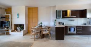 a kitchen with a table and chairs in a room at Exceptional Beachfront Villa Blue Cocoon in Pefkochori