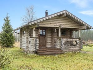 an old log cabin with a door in a field at Holiday Home Backcountry base by Interhome 