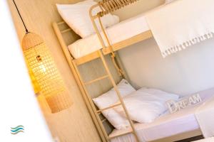 a room with a bunk bed with a ladder at Plataria Seaside Resort in Plataria +32 photos